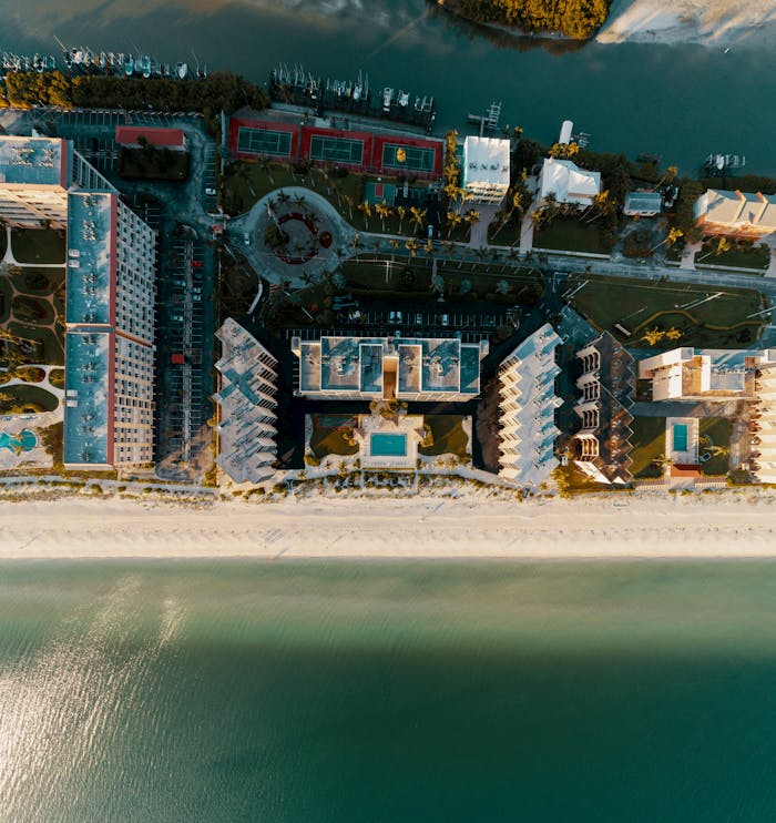Stunning aerial shot capturing luxury beachfront resorts in Bonita Springs, Florida, showcasing ocean vistas.
