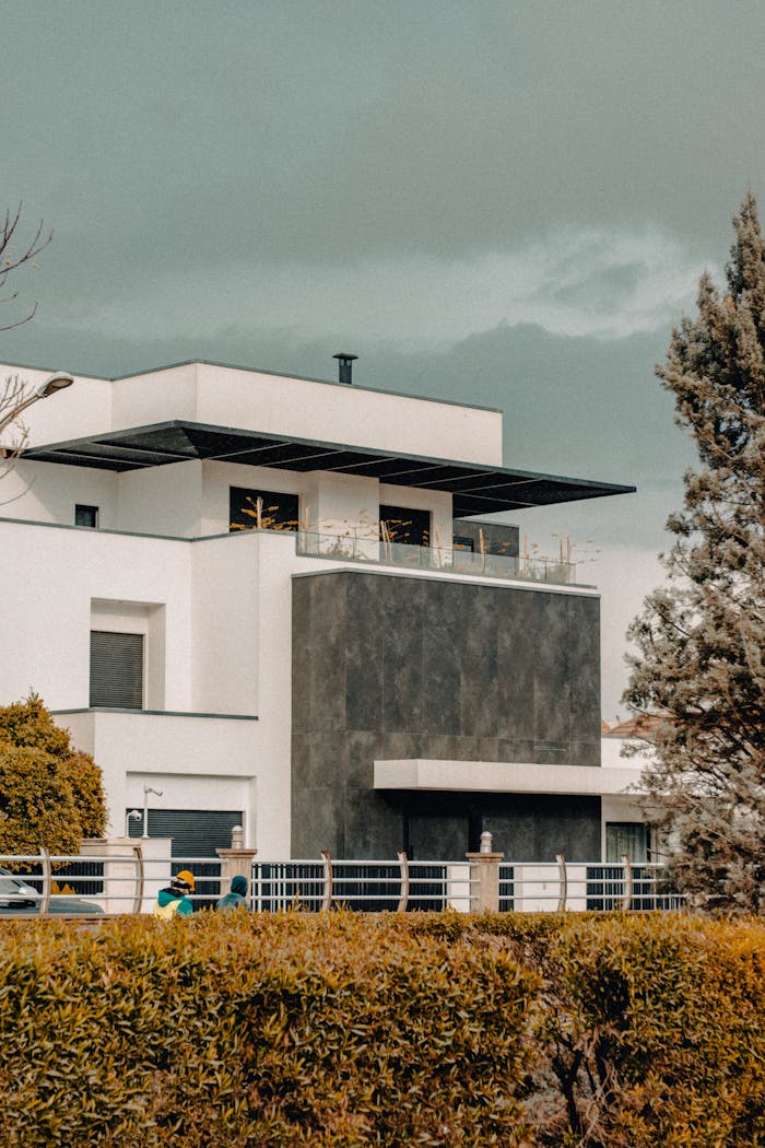 Contemporary house facade with geometric design elements and landscaping.